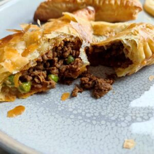 Tore Cheesy Keema Puff Pastry on a large gray plate