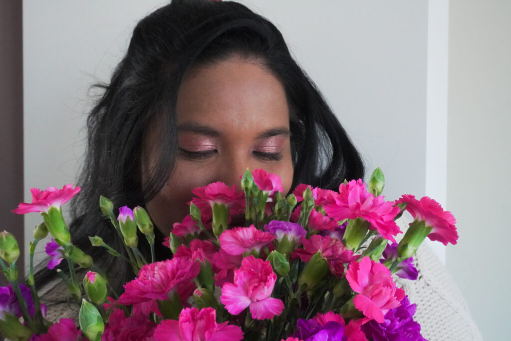 Author Minaa holding a bouquet of flowers