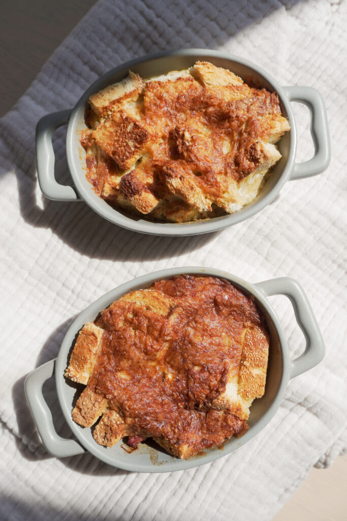 B roll 2: Breakfast Strata in two mini casserole dish on cream coloured textured cloth top view